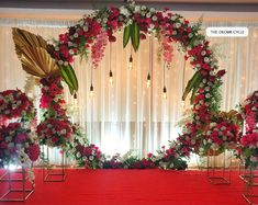 a red table topped with lots of flowers