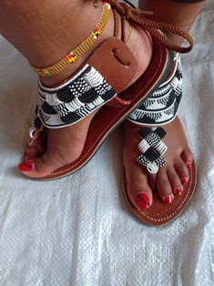 Maasai sandals, gladiators for women ,African beaded gladiators, women sandals,Summer sandals. This sandals are 100% handmade using maasai beads All sizes are available as we custom make them. For perfect fitting kindly use the last image as a guide. Ships via dhl express . Thank you for stopping by. Casual White Beaded Sandals, White Beaded Sandals With Round Toe, White Beaded Open Toe Sandals, Traditional White Sandals For Summer, Handmade Ankle Strap Sandals, Beaded Adjustable T-strap Sandals, Adjustable Beaded Sandals, African Sandals, Women Summer Sandals