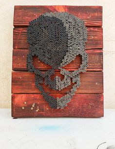 a wooden pallet with a metal skull on it