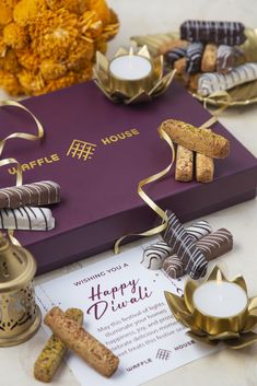 a purple box filled with lots of different types of cookies and crackers on top of a table