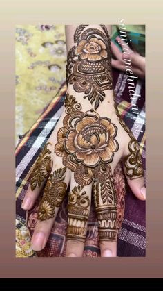 a woman's hand with henna tattoos on it