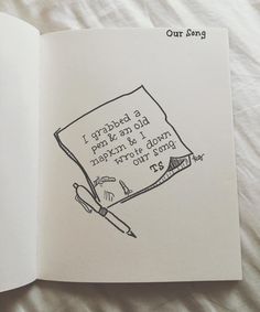 an open book with writing on it and a pair of scissors next to the page