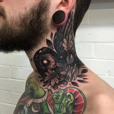 a man with a tattoo on his neck has an elephant and snake design on it