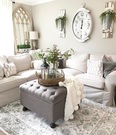 a living room filled with furniture and a large clock on the wall above the couch