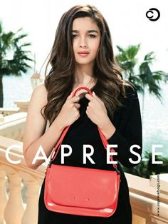 a woman holding a red purse in front of her face and the words caprese on it