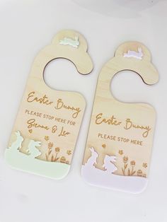 two wooden baby door hangers with bunny and rabbit designs on them, one for each child