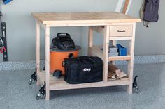 a workbench with tools and equipment on it in a garage or workshop area