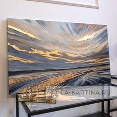 a painting on display in a room with a glass table and black shelf underneath it