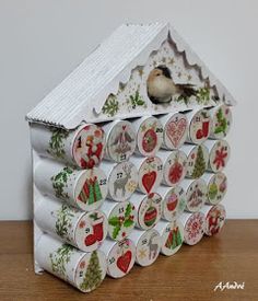 a bird is perched on the top of a house made out of christmas themed magnets