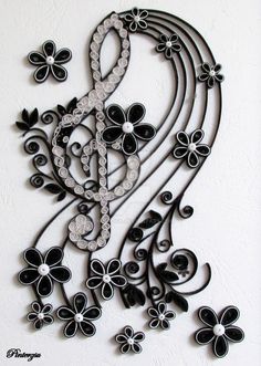 an intricate black and white wall hanging with flowers