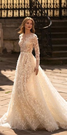 a woman in a wedding dress standing outside