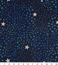 blue and white stars on a black background with a ruler in the foreground for scale