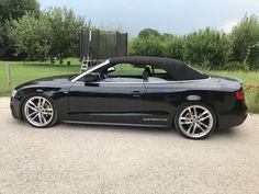 a black sports car parked in a parking lot