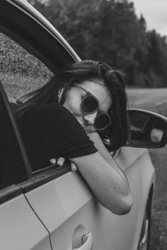 a woman leaning out the window of a car