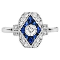 This beautiful ring is a vintage inspired style, the halo ring features round H color SI clarity diamond for its center, surrounded by French cut blue sapphire and round diamonds. This would make a wonderful engagement ring, or to commemorate an anniversary, to celebrate an April birthday, or just because it is beautiful. Ring Information Style: Art-deco Metal: 14K White Gold Total weight: 3.22 g. (approx. total weight) Center Gemstone Type: Diamond Shape: Round Average Color: H Average Clarity: April Birthday, French Cut, Estilo Art Deco, Handcrafted Rings, Beautiful Ring, Halo Ring, Diamond Shape, Cluster Ring, Ring Box