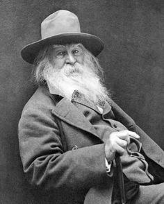 an old black and white photo of a man with a long beard wearing a hat