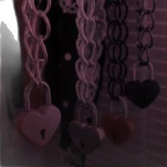 there are many heart shaped keys hanging on the wall