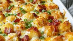 a casserole dish with bacon, green onions and cheese on the top is ready to be eaten