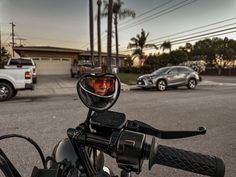 a motorcycle with a helmet and goggles on it's handlebars parked in a parking lot