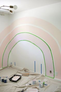 a room that has some paint on the walls and is being painted with rainbow colors