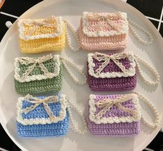 four small crocheted purses on a plate