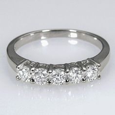 a five stone diamond ring on a white background