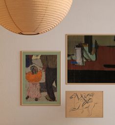 three paintings hang on the wall next to each other