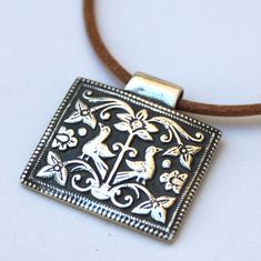 "This handmade fine silver pendant is another one of my favorites! The birds, flowers, curving tendrils and dots give it such a sweet whimsical look....yet is also has a rustic, ancient feeling like it might have come from Pompeii.  It hangs on a natural Greek leather cord with a sterling silver hook & eye clasp.   The silver pendant is approx. 8.5 grams and 1-1/8 inch wide. Cord is 16\"L.  This piece is created from an antique Afghan bronze jewelry die that I found in a bazaar in Islamabad, Pak Metal Clay Pendant, Clay Pendants, Metal Clay Jewelry, Precious Metal Clay, Bronze Jewelry, Gifts For Photographers, Recycled Silver, Pompeii, Polymer Clay Art