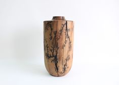 a wooden vase sitting on top of a white table