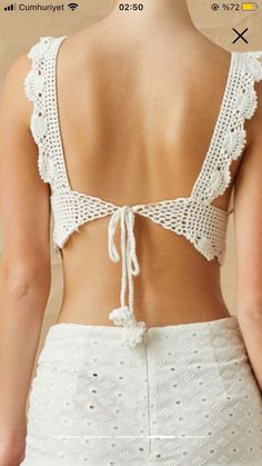 the back of a woman's top with crochet