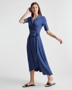 Fitted where you want it, flowy where it feels good. Our Tencel Jersey Midi Wrap Dress is the timeless classic everyone needs in their lineup. Eco-cool and all-day comfy with a rounded collar and modern midi length, it’s as soft as it is sustainable, and it’s part of our growing knit-dress collection. Also offered in sizes 1X-3X.  | Quince | Women's Tencel Jersey Midi Wrap Dress in Navy, Size XS Quince Blue, Wrap Dress Midi, Jersey Wrap Dress, Midi Wrap Dress, Dress Out, High Quality Dress, Perfect Wedding Dress, Elbow Length Sleeve, Quince