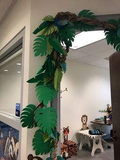 an office decorated with paper leaves and jungle animals