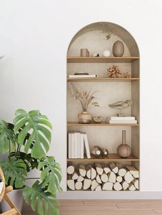 a shelf filled with books and vases next to a potted plant