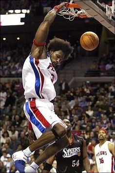 a man dunking a basketball into the air