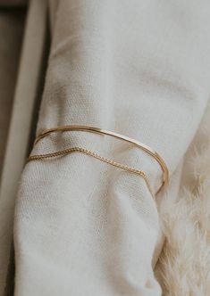 We attached one of our favorite chains to our classic hammered cuff for a 2-in-1 stack and we're obsessed with the outcome. Wire is hand shaped and lightly hammered for texture. Stevie Chain is attached to give a layered cuff and chain look. Available in 14kt Gold Fill + Sterling Silver. Shop our complete Cuff Collection. Handmade in Eau Claire, WI. Our jewelry is handmade so each piece will be unique and may vary slightly from what is pictured. Mixed Metal Bracelets, Copper Uses, Everyday Wear Jewelry, Handmade Jewelry Designs, Circle Studs, Hand Shapes, Silver Shop, Herkimer Diamond, Freshwater Pearl Necklaces