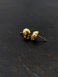 ♥Make a bold statement with these solid 9k gold skull stud earrings, perfect for dark lovers and fans of     gothic fashion. Inspired by human anatomy and hand-polished using 3D printing      technology. Each earring is a sculptural and geometric work of art. The Memento Mori philosophy is     embodied in these minimalist and edgy earrings, making them a perfect gift for men,     women, or any special someone.  ♥Please note that lighting variations may cause slight differences in color appearanc Gold Skull-shaped Earrings, Dark Lovers, Memento Mori Jewelry, Gothic Mode, Earrings Gothic, Edgy Earrings, Goth Earrings, Edgy Jewelry, Small Skull