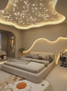 a large bed sitting in a bedroom next to a window with lights on the ceiling