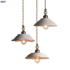 two pendant lights hanging from chains with one light on each side and the other off