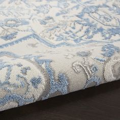 a close up view of a blue and white rug