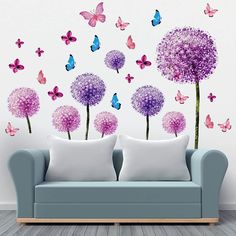 a living room with butterflies and flowers on the wall