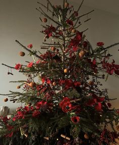 a christmas tree decorated with red and gold ornaments