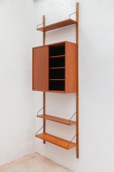 a wooden shelf with several shelves on it