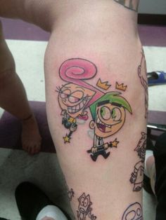 a cartoon character tattoo on the leg of a person's leg, with other characters around it