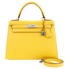 This authentic Hermès 28 cm Jaune de Naples Yellow Epsom Kelly Sellier is in pristine condition with the protective plastic intact on the hardware. Hermès bags are considered the ultimate luxury item worldwide. Each piece is handcrafted with waitlists that can exceed a year or more. The ladylike Kelly is classic and refined, a beautiful addition to any sophisticated wardrobe. The Sellier style is defined by sharper edges and rigid corners as opposed to the more relaxed Retourne version. Sunny Ja Naples Yellow, Sophisticated Wardrobe, Hermes Kelly 25, Kelly Cut, Kelly Sellier, Hermes Orange, Hermes Kelly Bag, Satchel Tote Bag, Kelly Bag