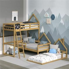 a child's bedroom with two bunk beds and a mountain mural