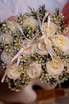 a bridal bouquet with white roses and baby's breath