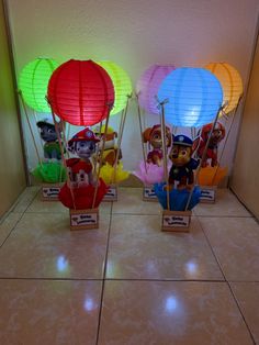 three small lanterns with paw patrol characters on them are sitting on the floor next to each other