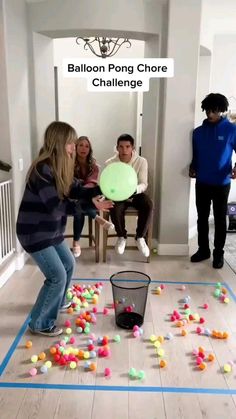 a group of people in a room playing with balls