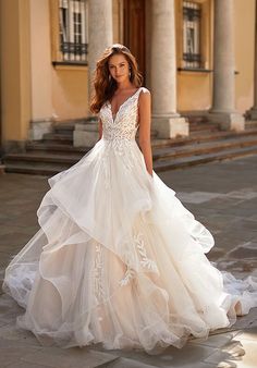 a woman in a wedding dress is standing outside