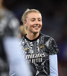 a female soccer player is smiling for the camera